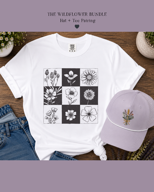 White t-shirt with floral design and matching cap on a wooden surface