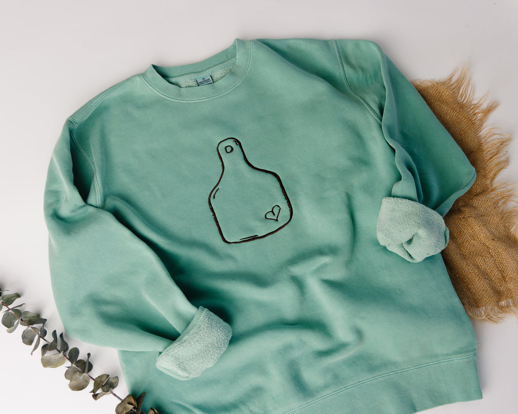 Light blue sweatshirt with a design on a white background