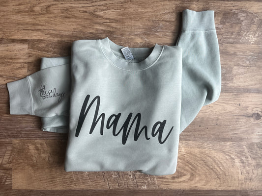 Gray sweatshirt with text on a wooden surface