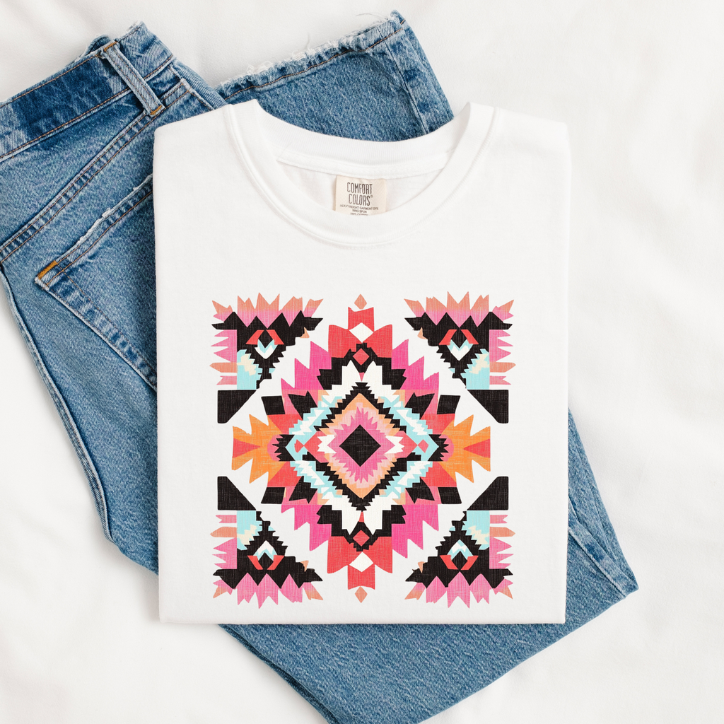 White t-shirt with a colorful geometric pattern on blue jeans