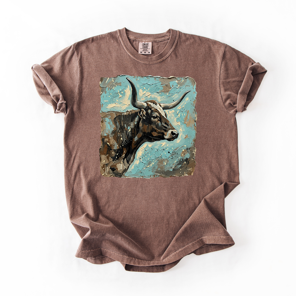 Brown t-shirt with a graphic of a cow on a white background