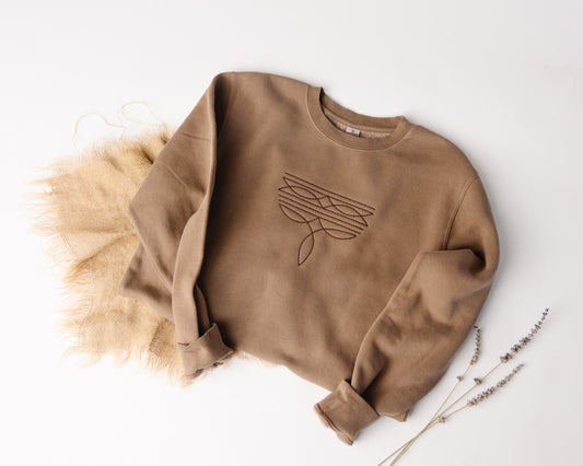 Brown sweatshirt with a western design on a white background