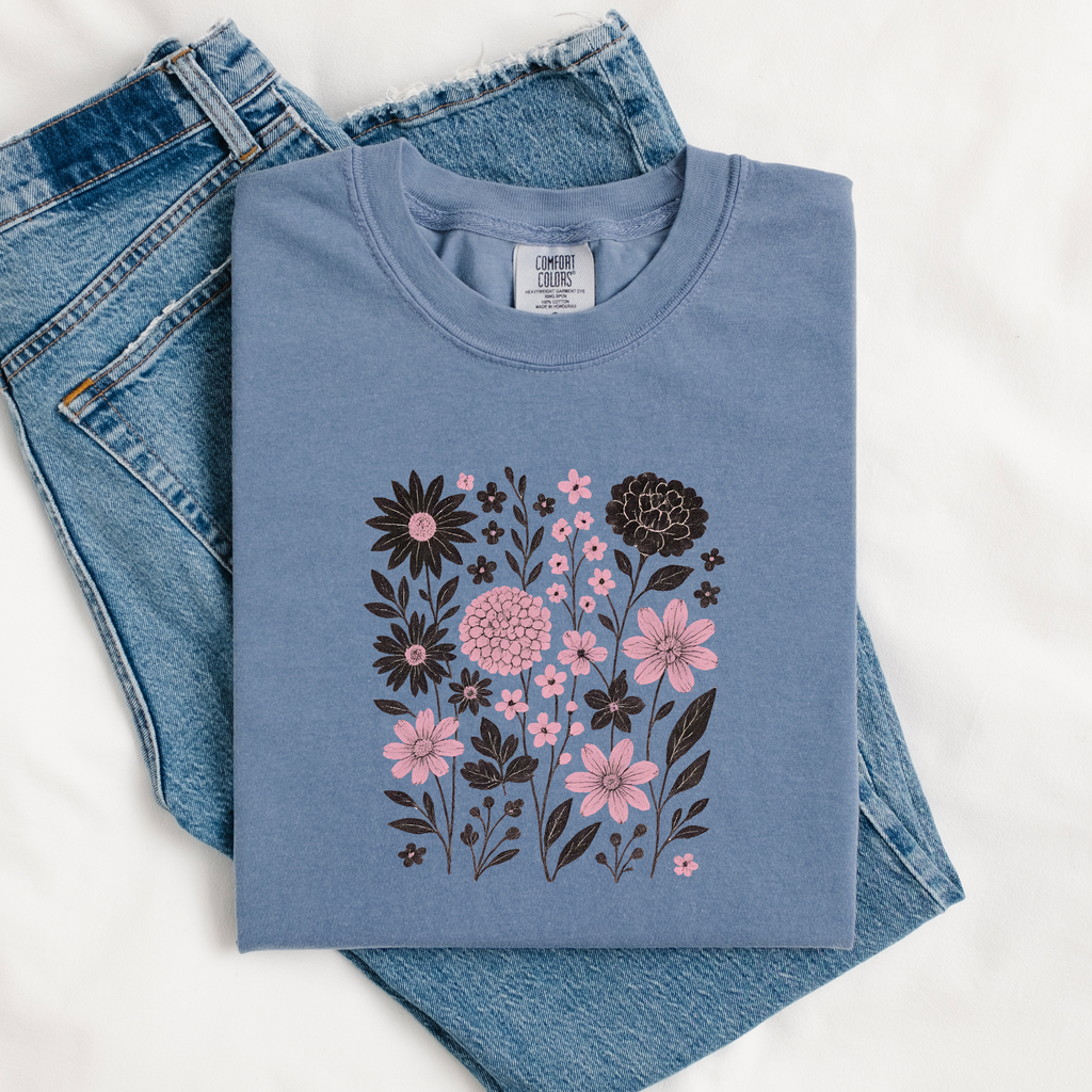 Folded blue sweatshirt with floral design on jeans