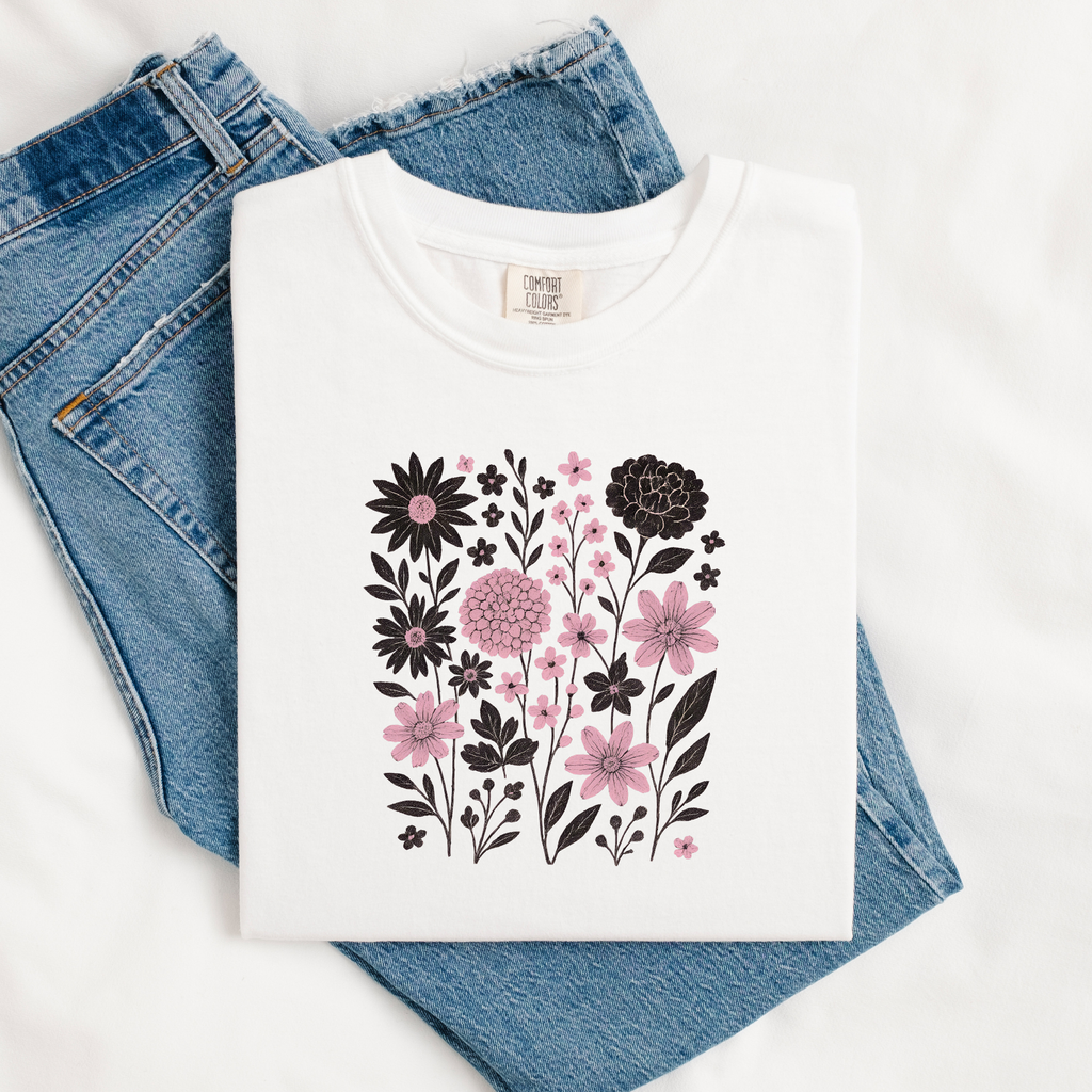 White t-shirt with floral design on blue jeans
