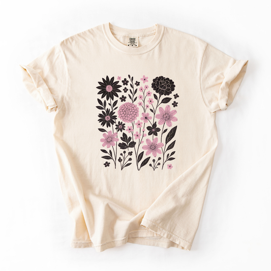 Gray t-shirt with floral design and blue jeans on a marble surface