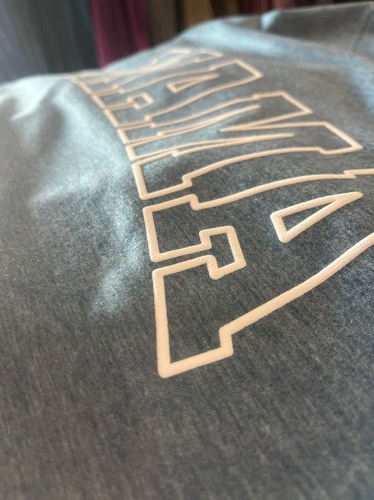 A blue crewneck sweatshirt with the word 'MAMA' printed on the front in white, displayed on a hanger.