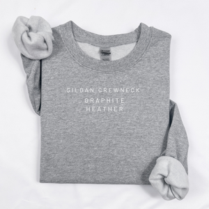 Gray sweatshirt with 'Gildan Crewneck Graphite Heather' text on a white background