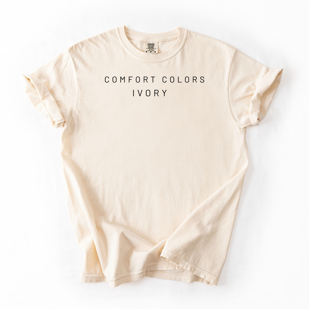 Beige t-shirt labeled 'Comfort Colors Ivory' on a white background