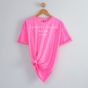 Neon pink t-shirt on a hanger with 'Comfort Colors' text.