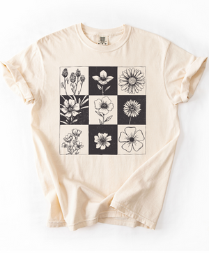 Beige t-shirt with black and white floral pattern on a white background