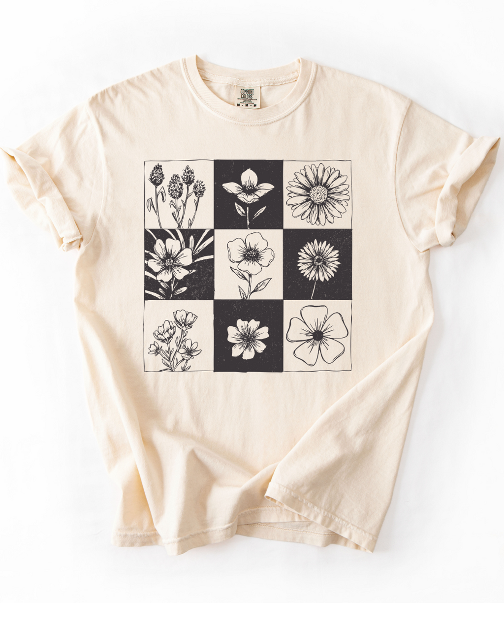 Beige t-shirt with black and white floral pattern on a white background