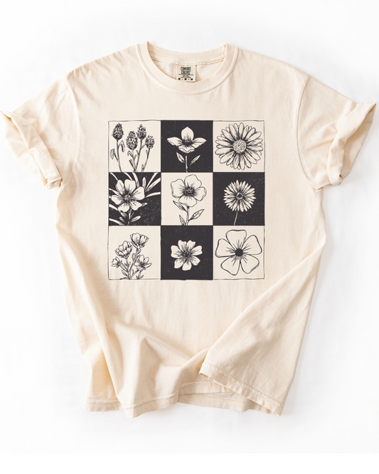 Beige t-shirt with black and white floral pattern on a white background